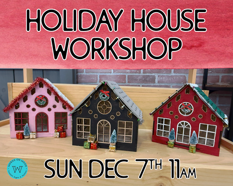 Photo of three wood holiday houses painted and decorated with holiday decor